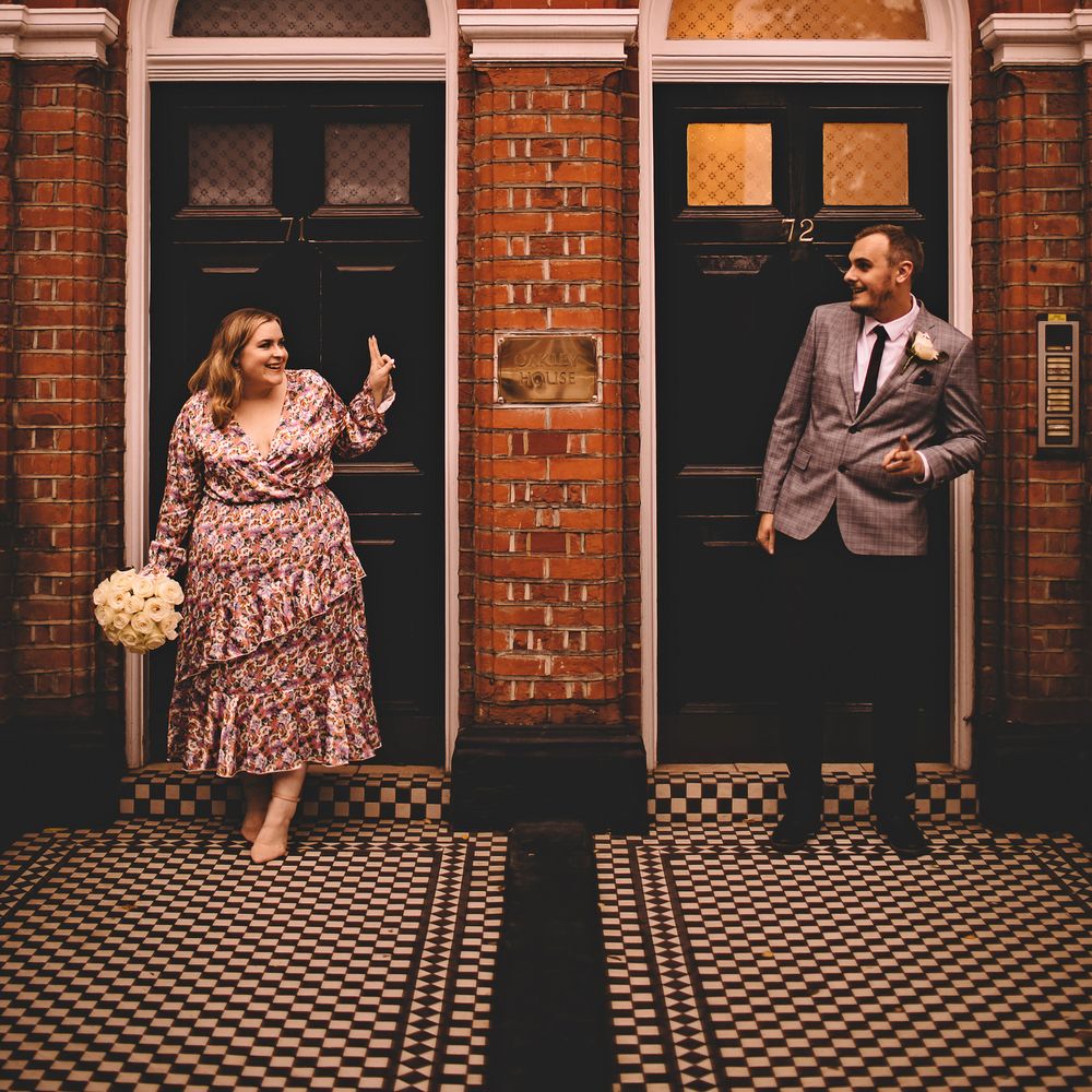 Bride & groom stand in doorways as they look across at one another