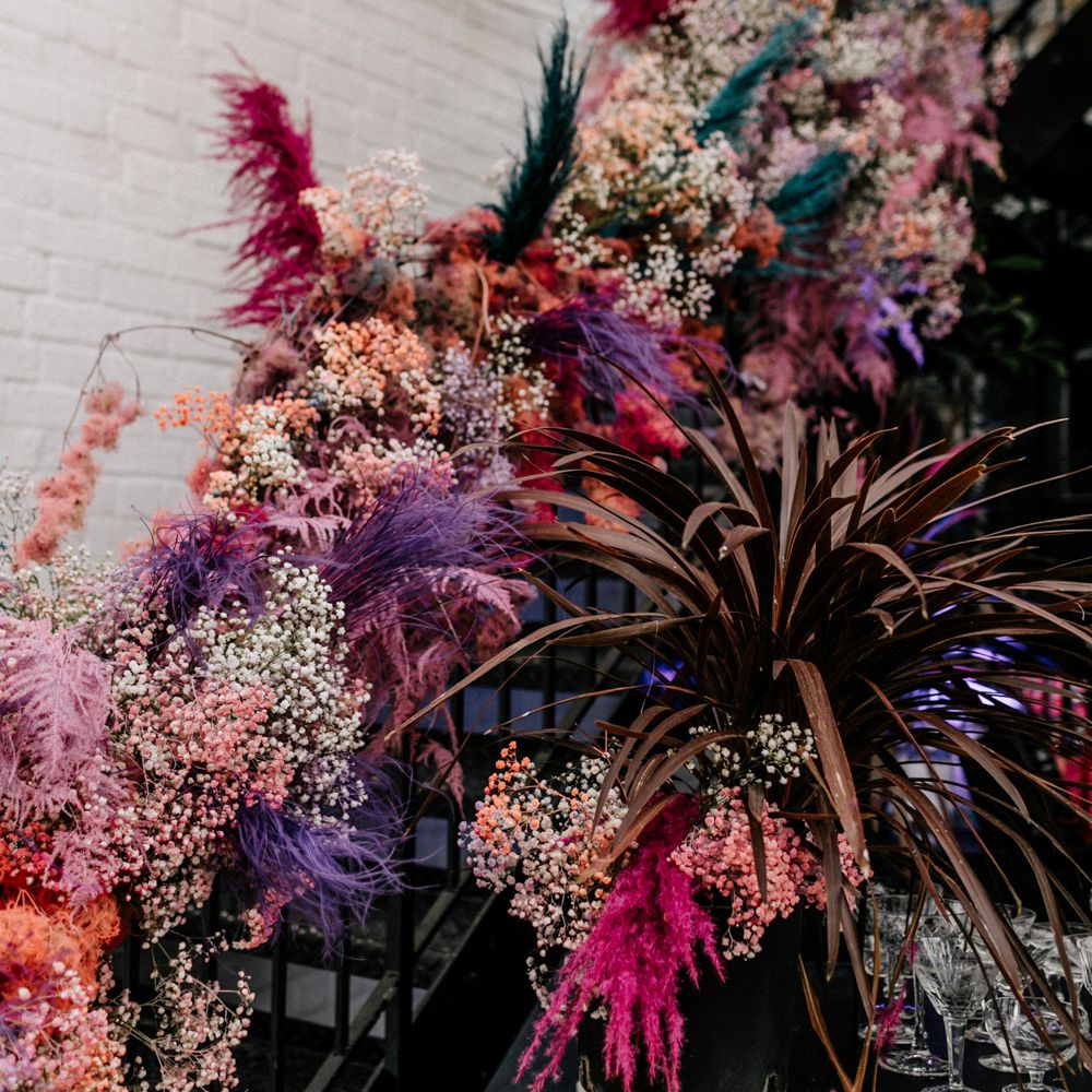Coloured pampas grass staircase wedding floral arrangement 