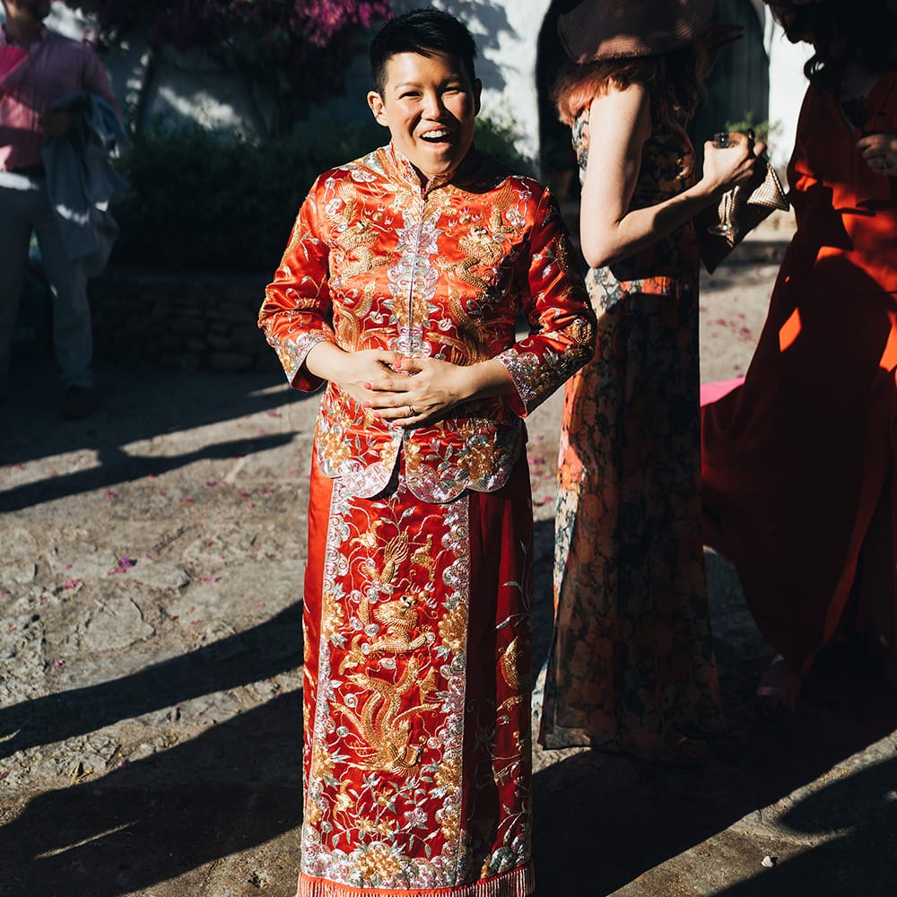 Bride smiles during traditional Chinese tea ceremony in Menorca