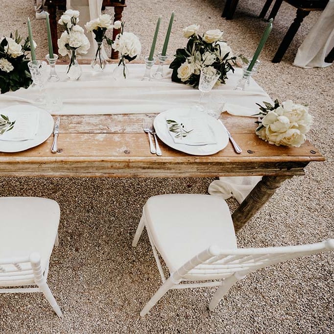 Rustic tablescape complete with white table runner and white florals  | Royal Studio