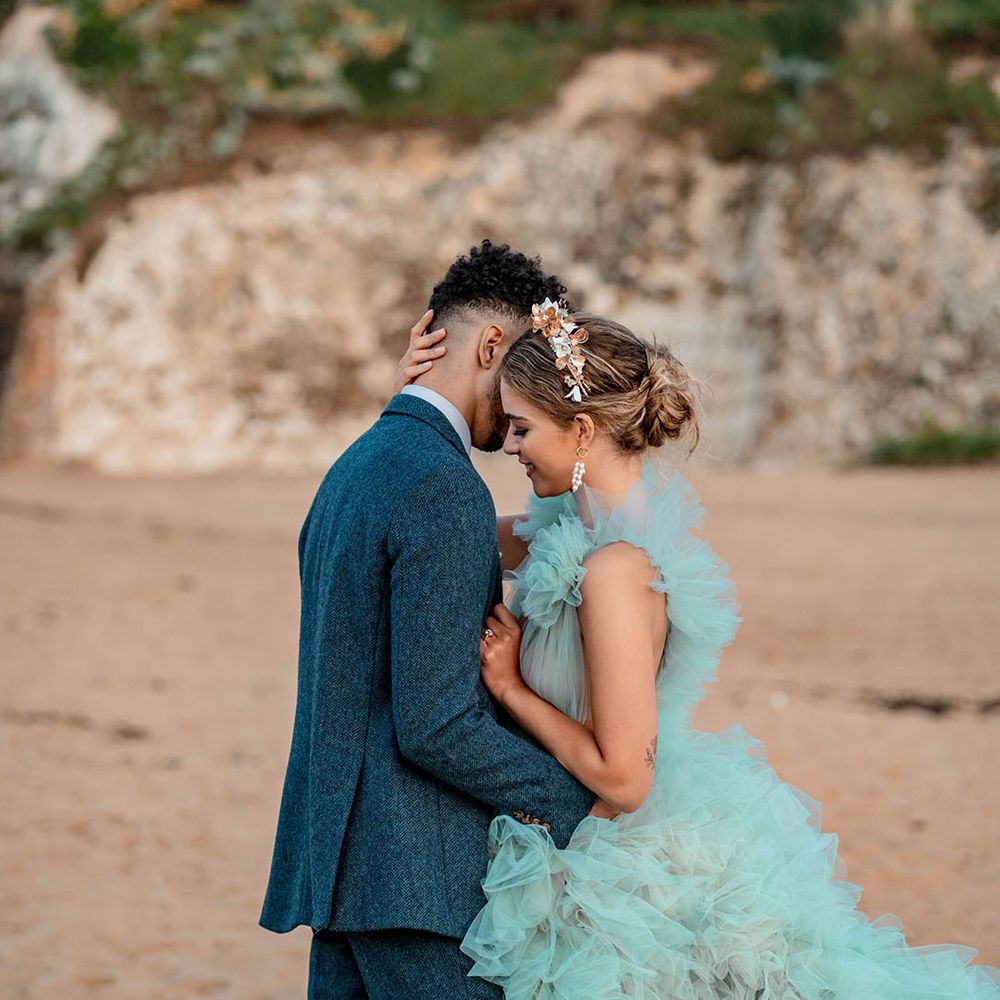 Coastal wedding inspiration at Botany Bay, Kent with bride in a mint green wedding dress and groom a blue wool suit 