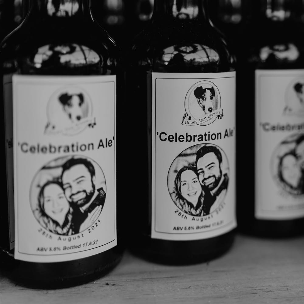 Four bottles of personalised ale reading 'Celebration Ale' for outdoor wedding in Bedfordshire
