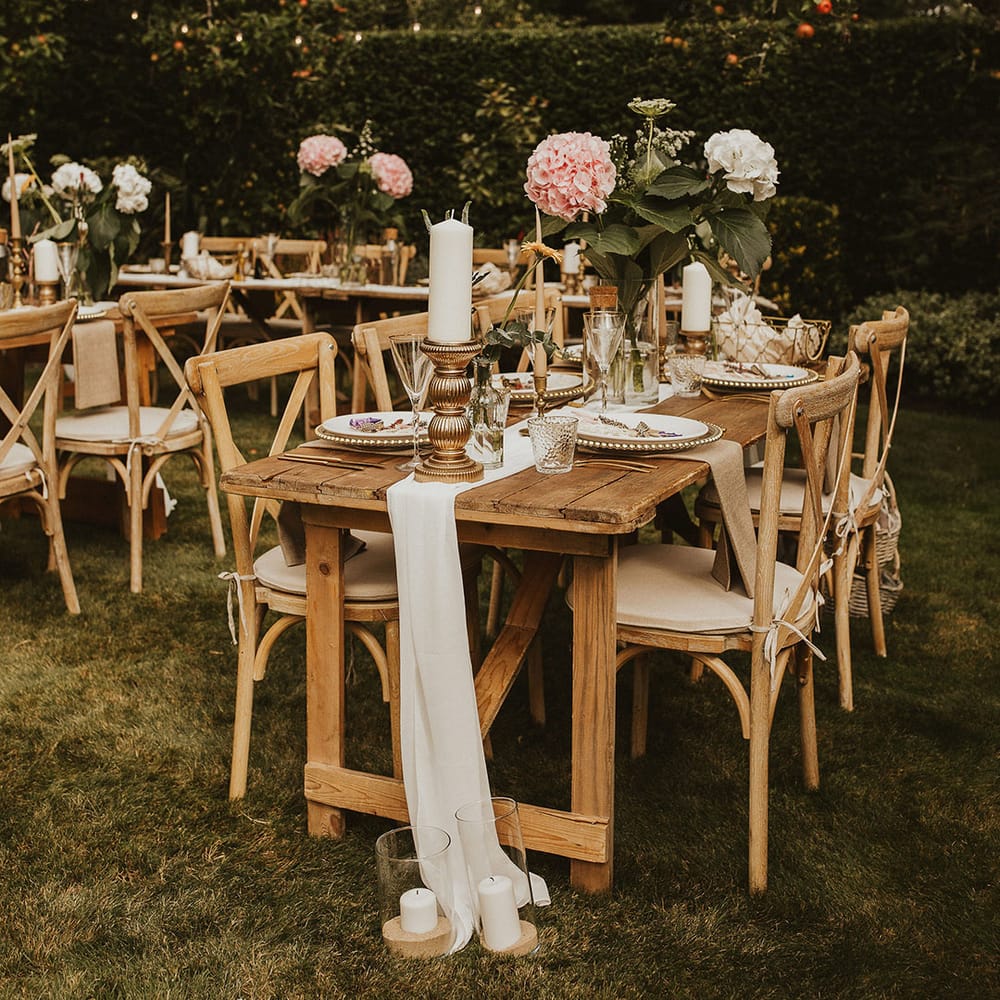 Rustic tablescapes complete with linen table runner and large florals throughout the middle