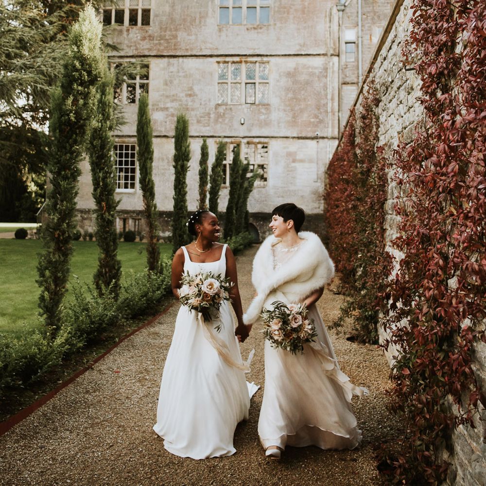 Elmore Court lesbian wedding with two brides in A line wedding dresses holding baby pink rose wedding bouquets 