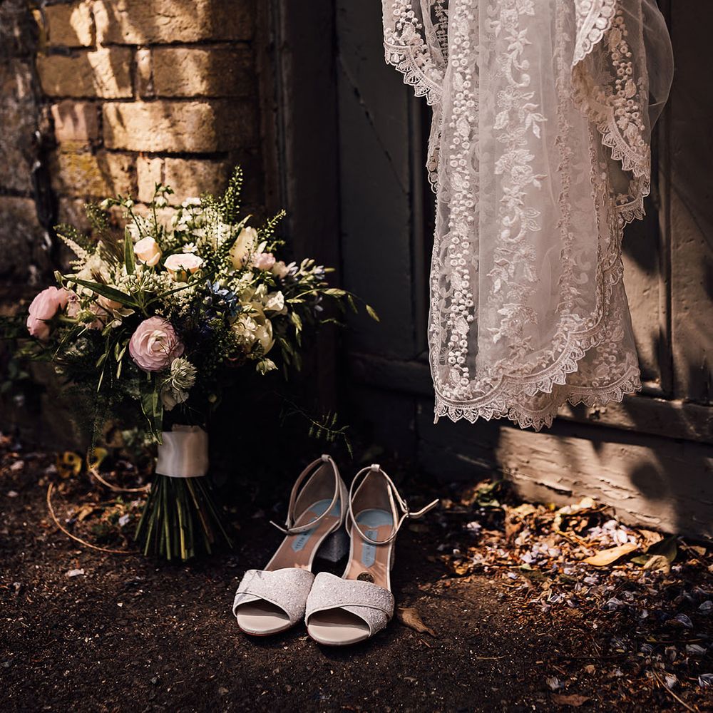 Bride's Charlotte Mills wedding shoes and lace embroidered veil and bridal bouquet 