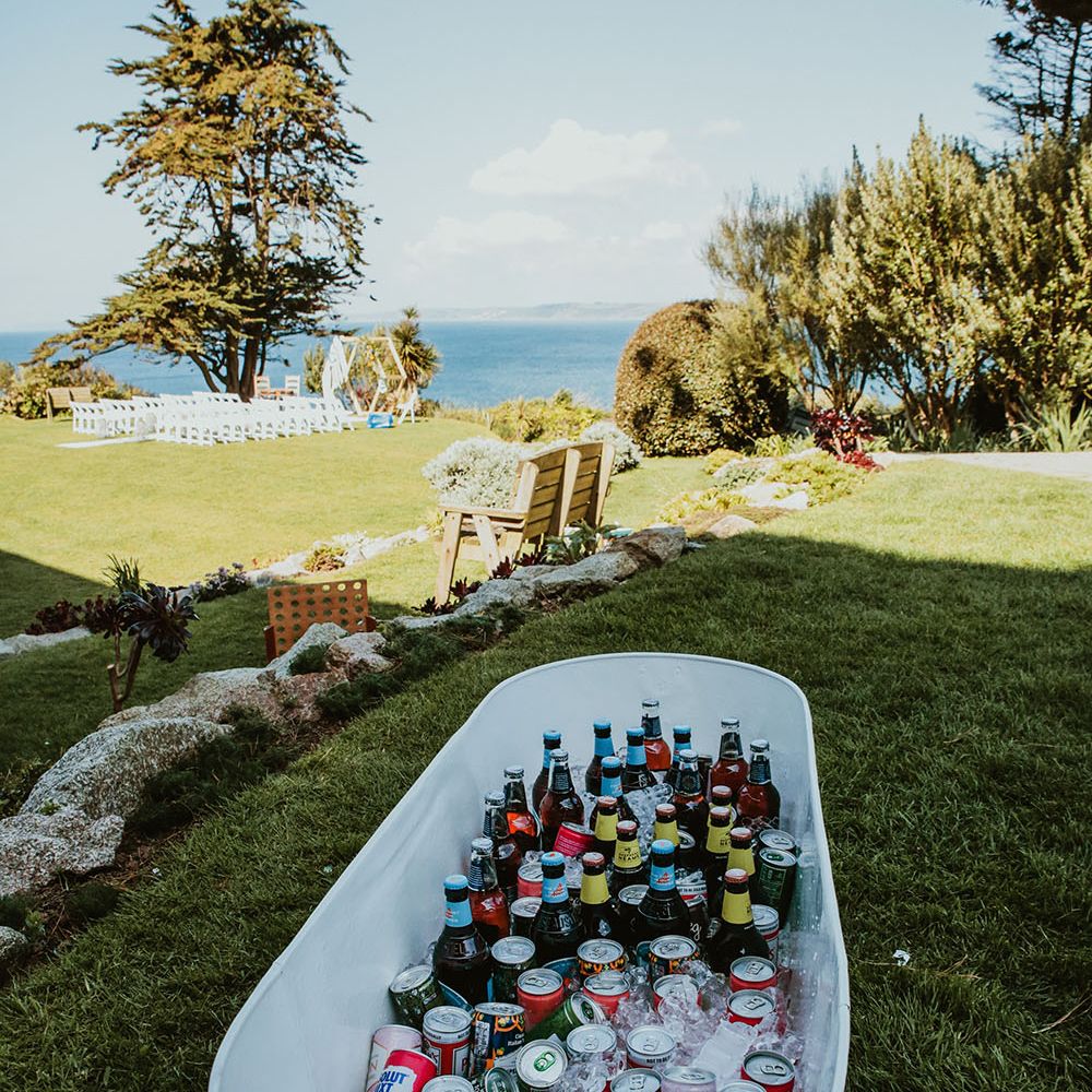 Bath filled with alcohol outdoors on wedding day in Cornwall 