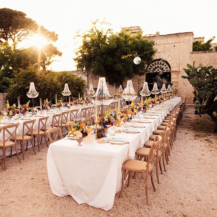Destination wedding in Puglia, Italy with chandelier installations for the outdoor wedding reception 