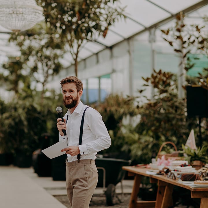 Groomsman doing a speech in front of greenery at the Architectural Plants Venue