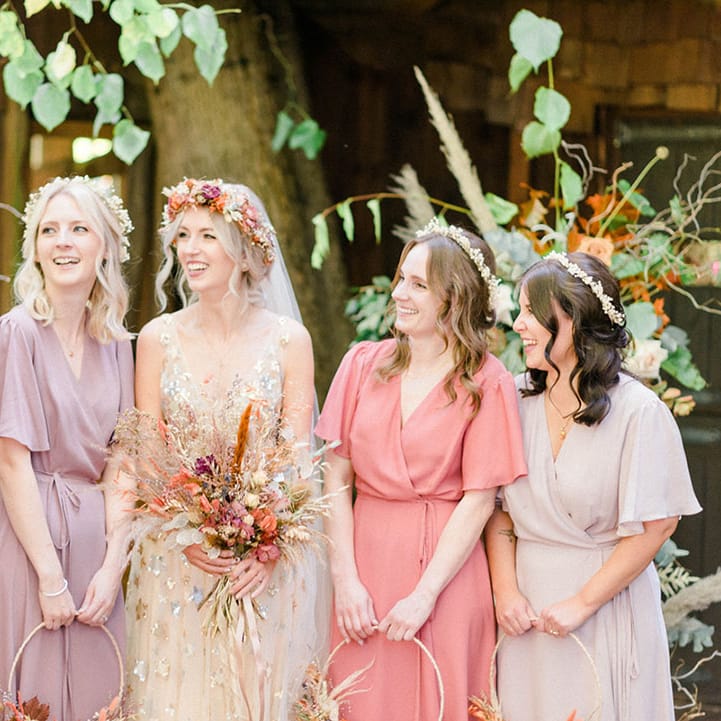 Bride in star sequin wedding dress stands beside her bridesmaids in Rewritten Bridesmaid dresses 