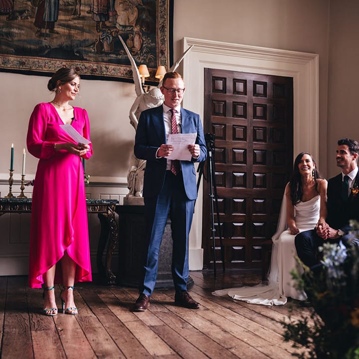 Wedding guests stand and give personal wedding readings at the wedding ceremony 