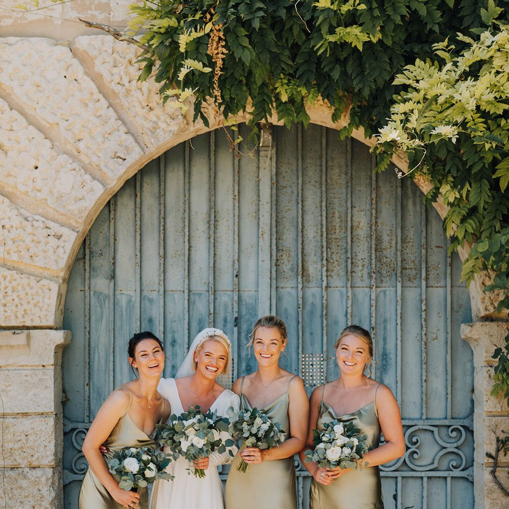 bridal party photograph with sage green satin bridesmaid dresses 