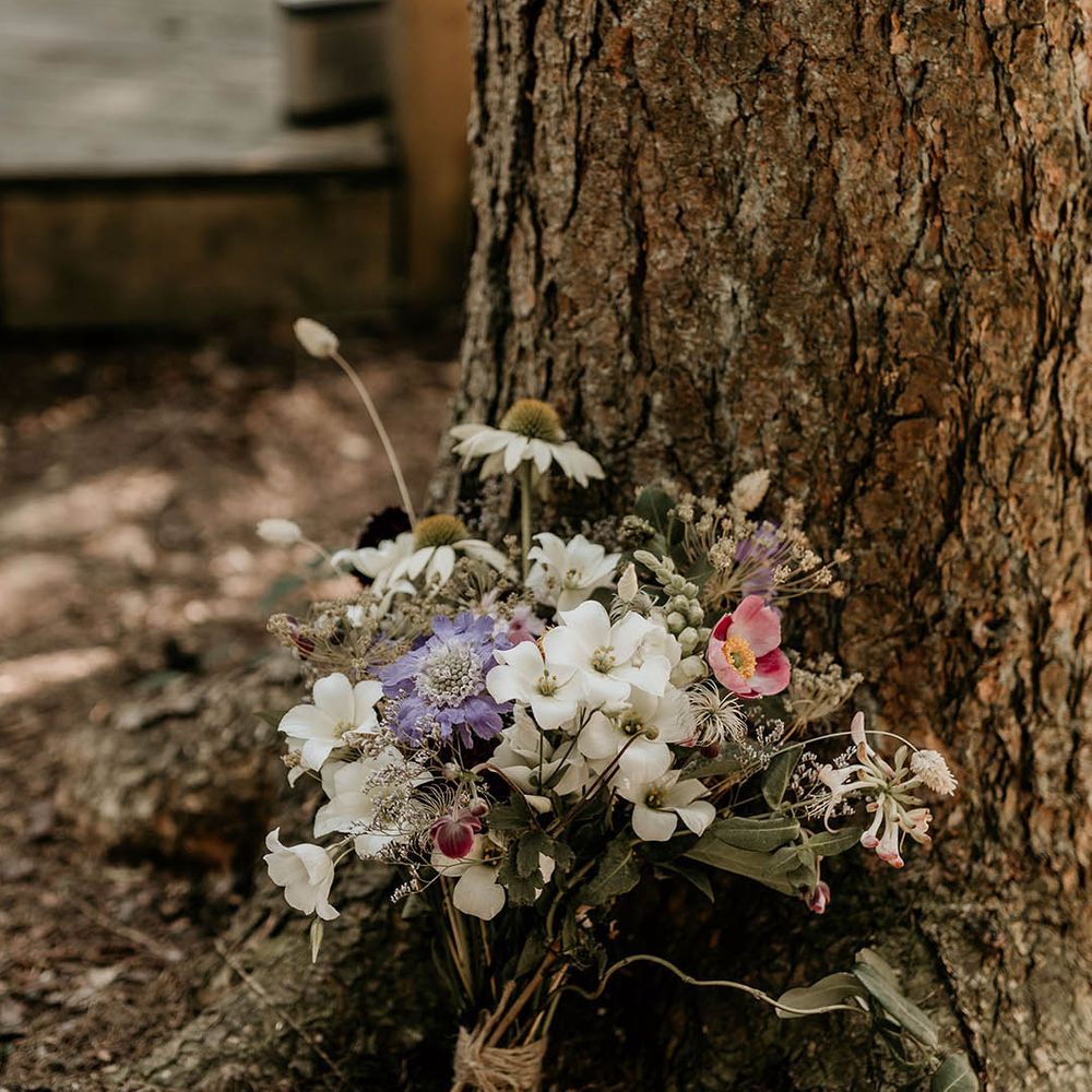 British grown purple and white wildflowers make up the bride's wedding bouquet 