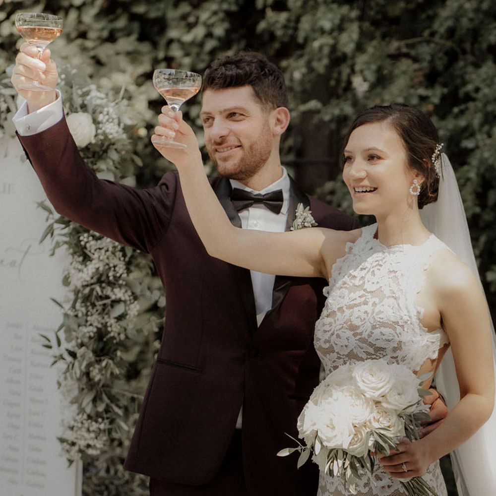 Bride and groom toast together at their outdoor wedding 