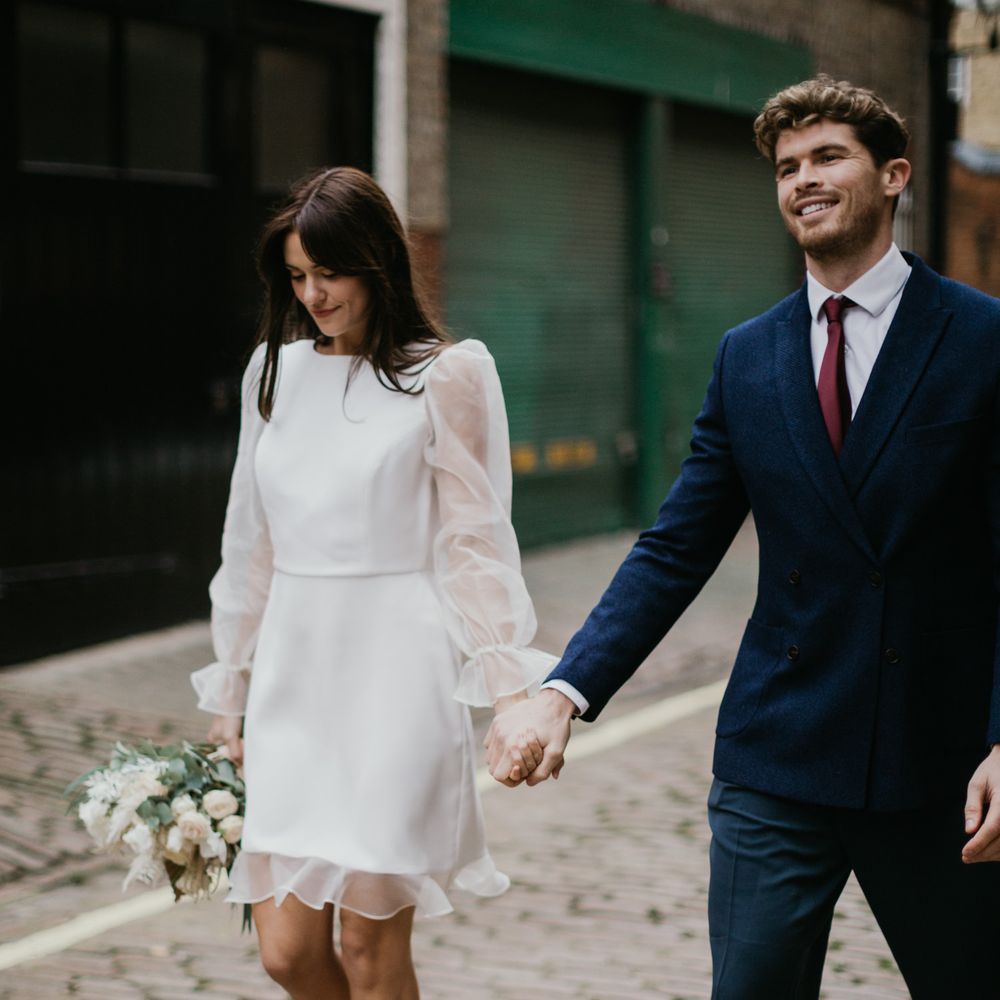 High neck wedding dress with frill hem and sheer sleeves by Story Of My Dress bridal