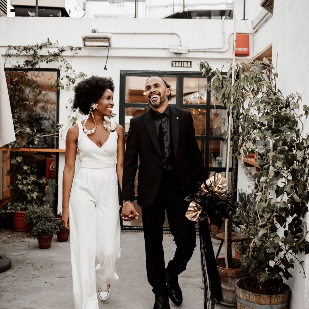 Bride & groom walk hand in hand 