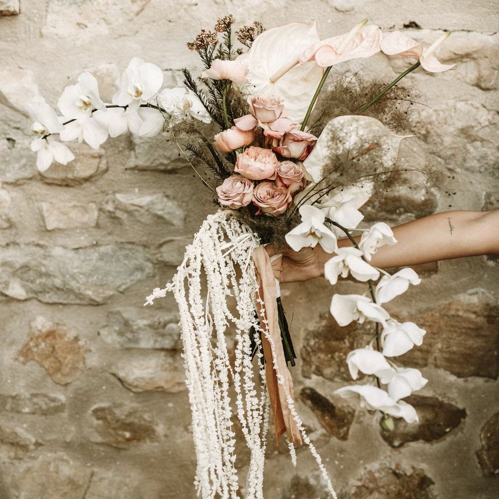 boho wedding flowers bouquet with pink roses, orchids, anthuriums and dried grasses 