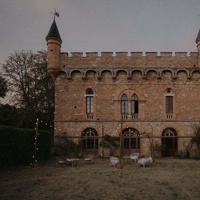 Château de Caumont castle orangery with festoon lit outdoor seating area