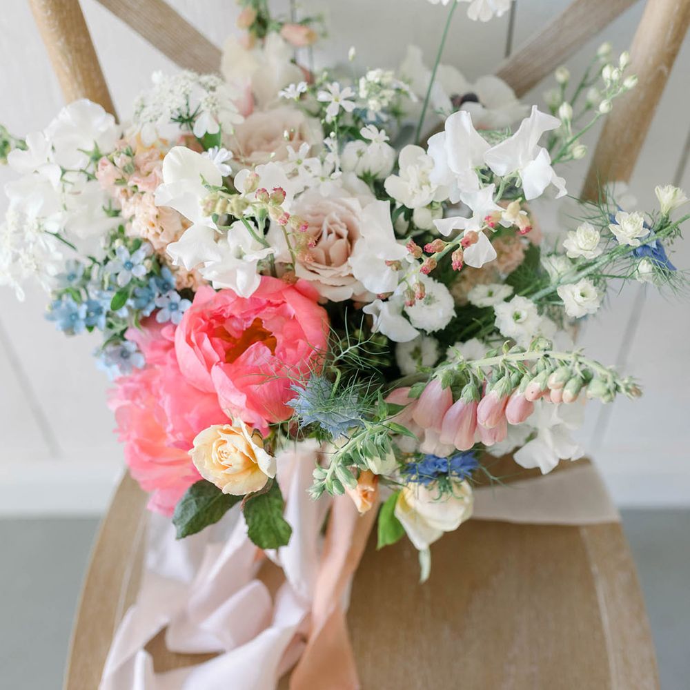 Wildflower wedding bouquet with coral peony, stocks, roses and cornflowers