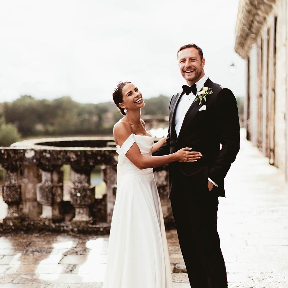 Bride & groom embrace outdoors on balcony 