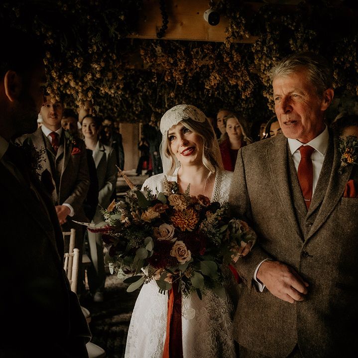 Father of the bride in a brown wool suit walking his daughter down the aisle in a lace wedding dress at her Lyde Court wedding 