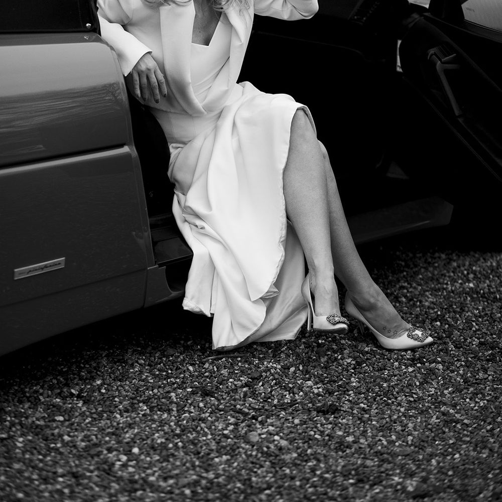 Bride sips champagne on her wedding day 