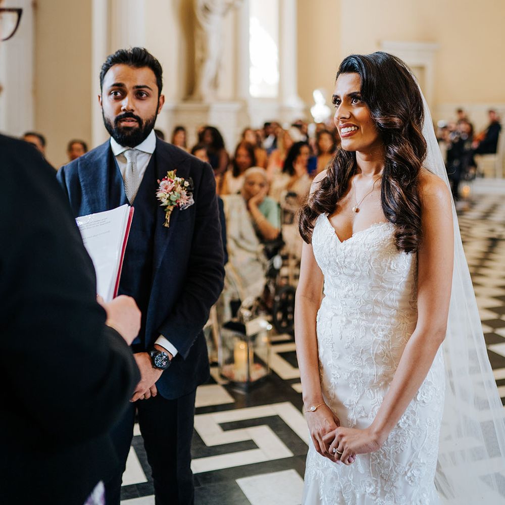 Bride & groom during wedding ceremony at Syon Park before reading personal vows