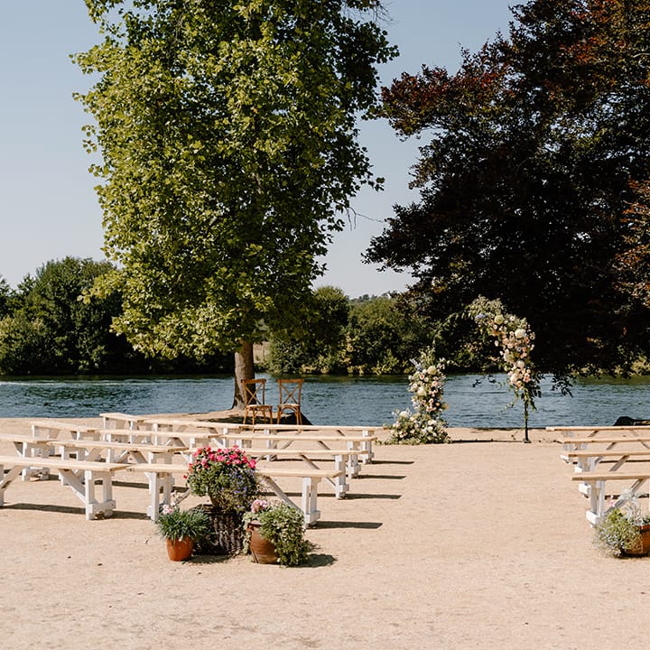 Outdoor wedding ceremony on the bank of the River Thames complete with floral archway 