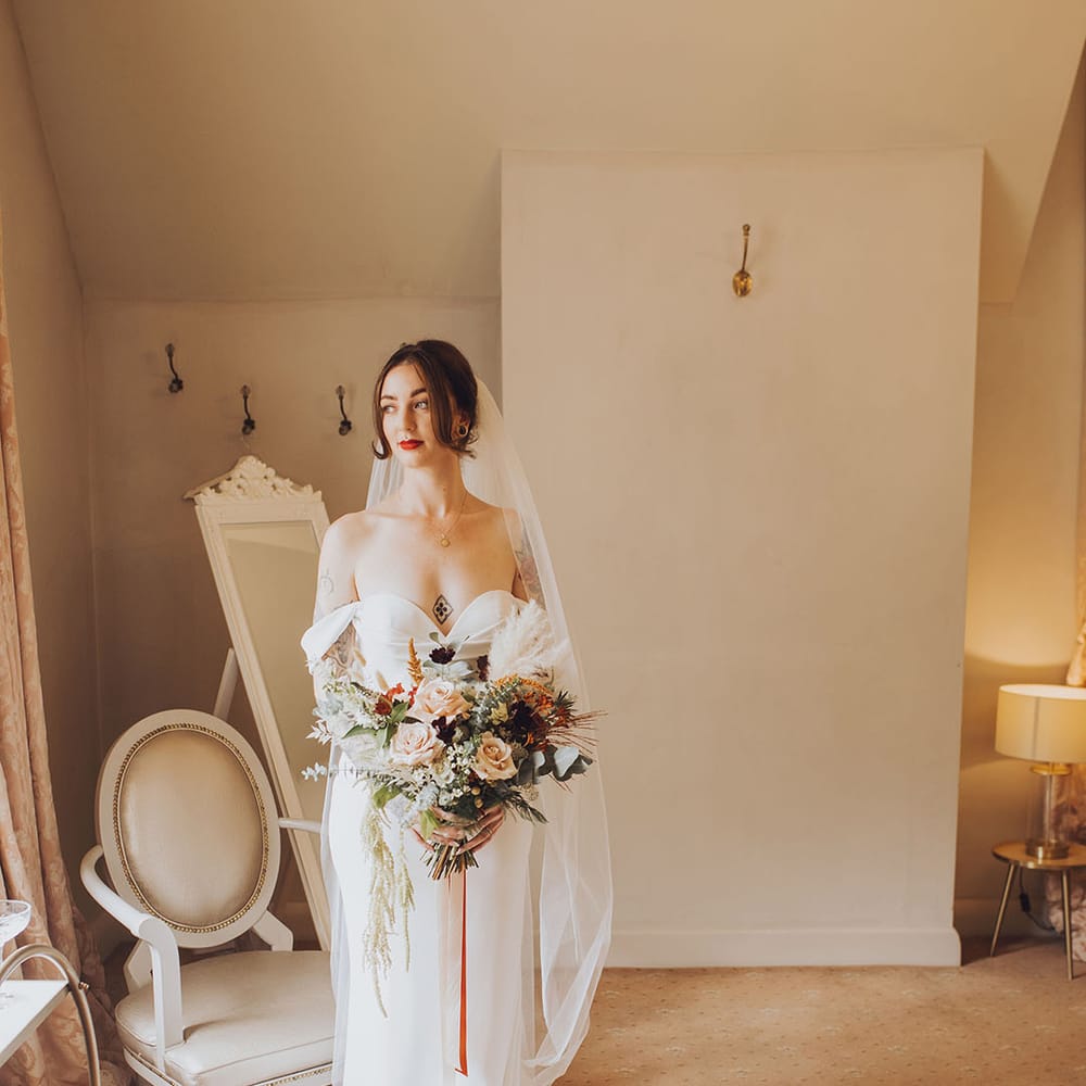 Bride in Vera Wang wedding dress with off the shoulder styling and sweetheart neckline 