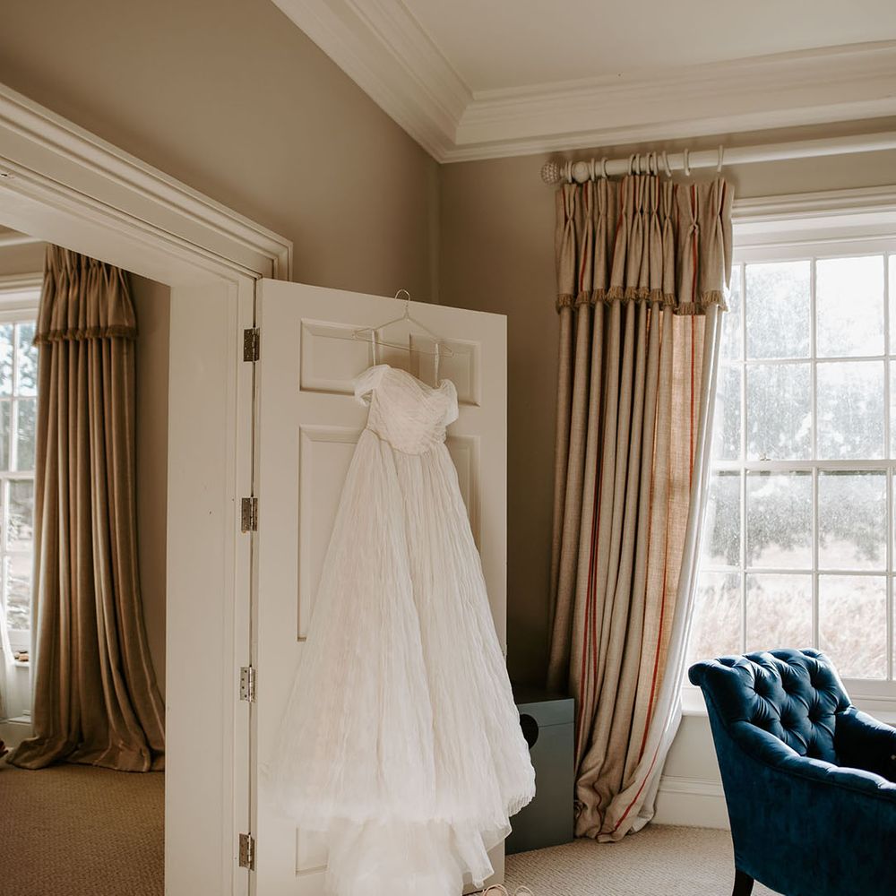 The bride's off the shoulder wedding dress with pale pink Loeffler Randall wedding shoes 
