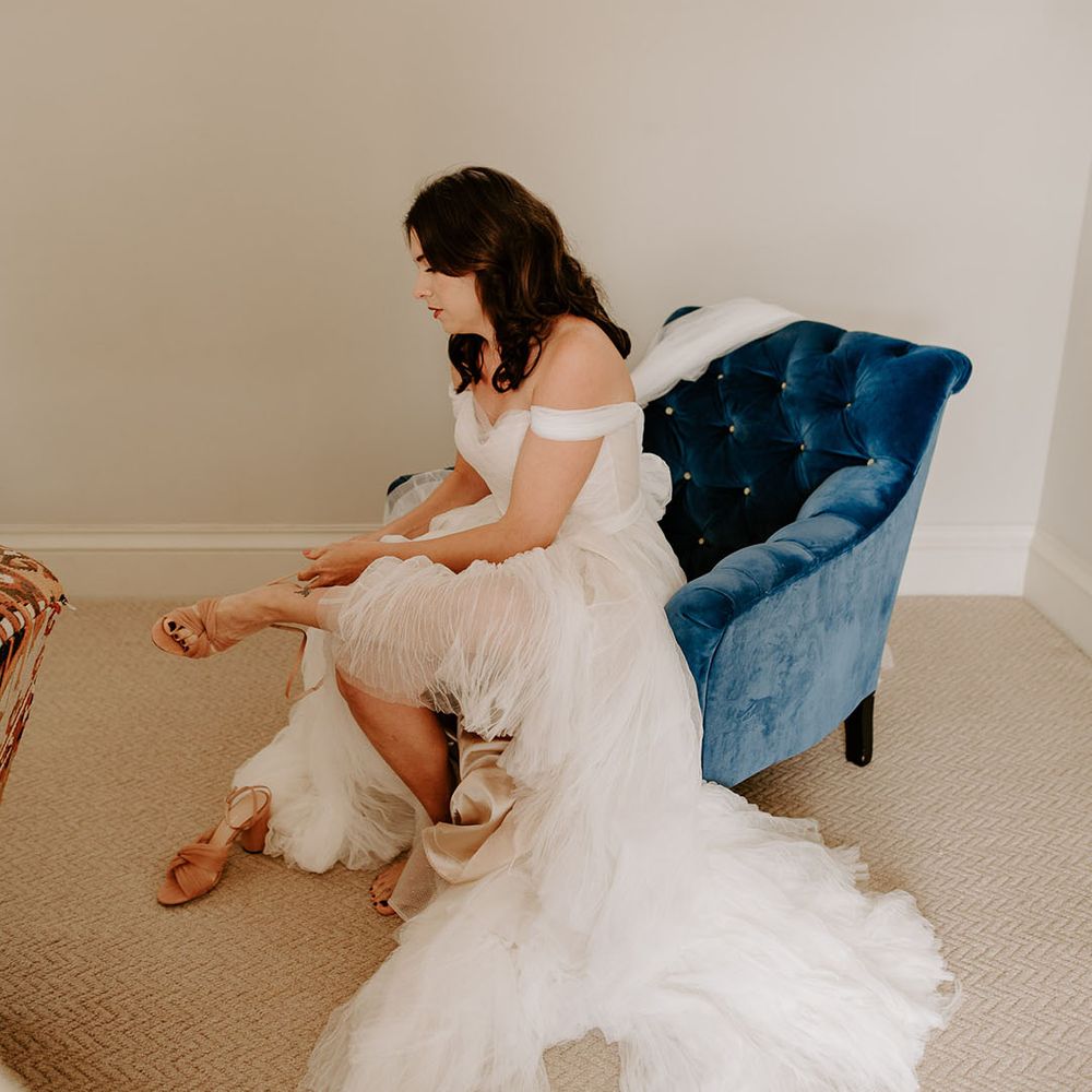 The bride puts on her pink Loeffler Randall wedding shoes for her Wilderness Reserve wedding