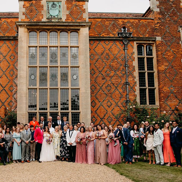 North Mymms Park wedding venue with the whole wedding party posing with the bride and groom for the day 