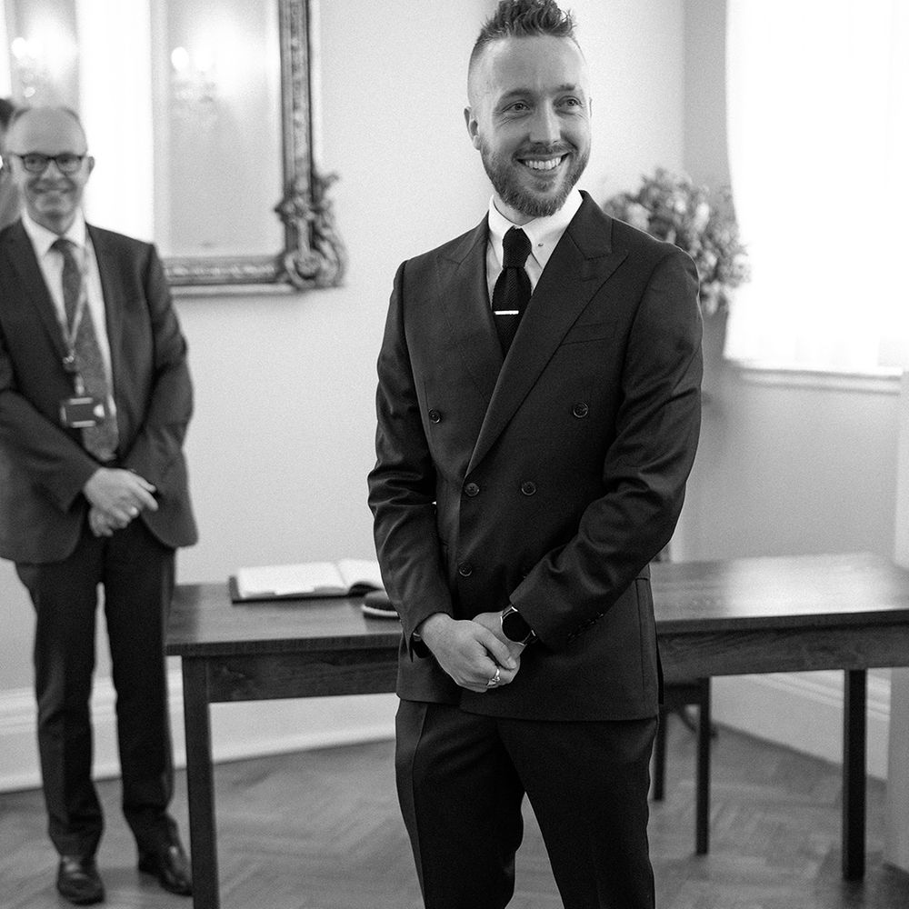Groom standing at the altar in a black suit of registry office wedding in London 