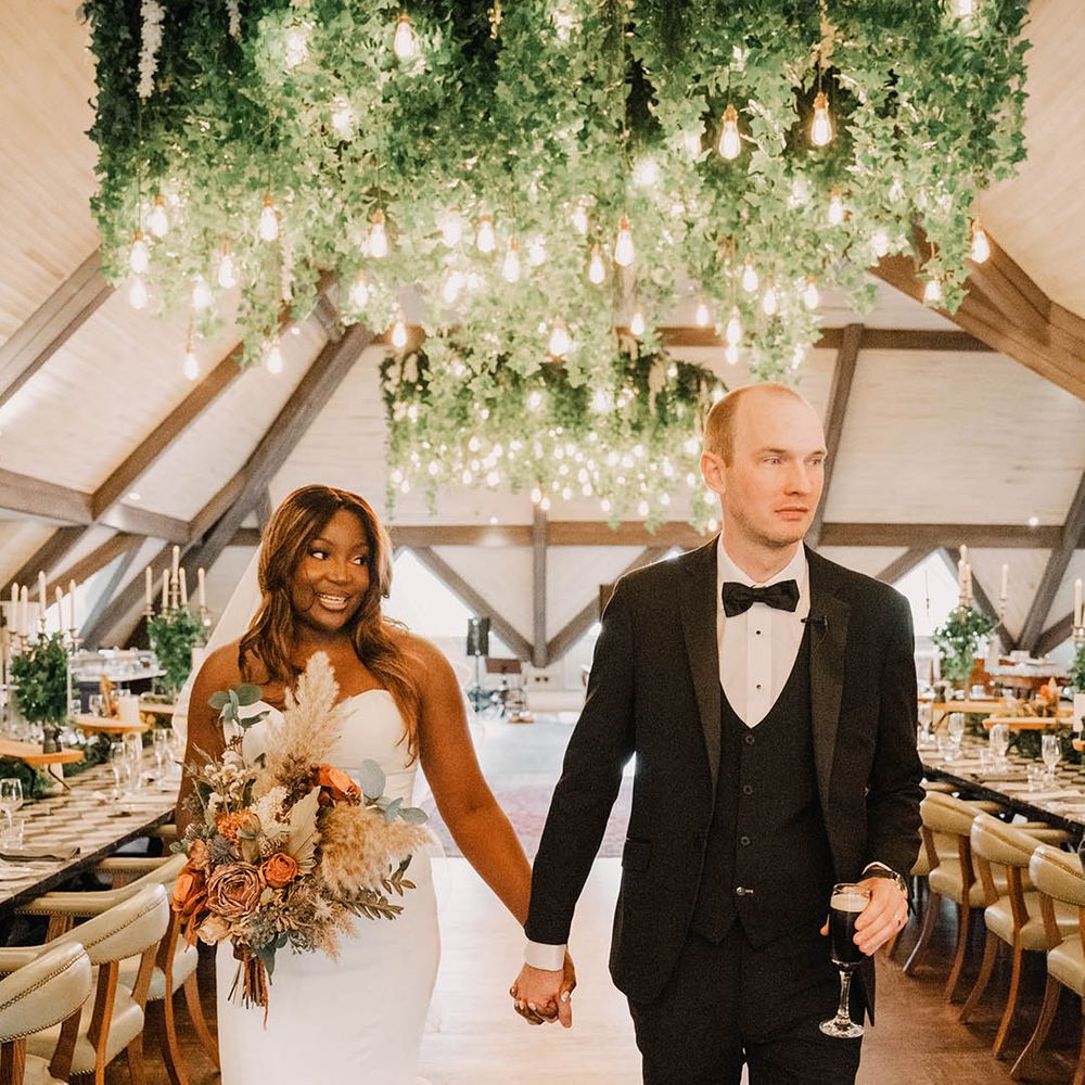 Bride and groom walking around their wedding breakfast hand in hand at the Templepatrick Northern Ireland wedding 