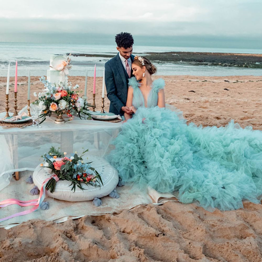 Bride wearing a blue wedding dress with ruffles and tulle 