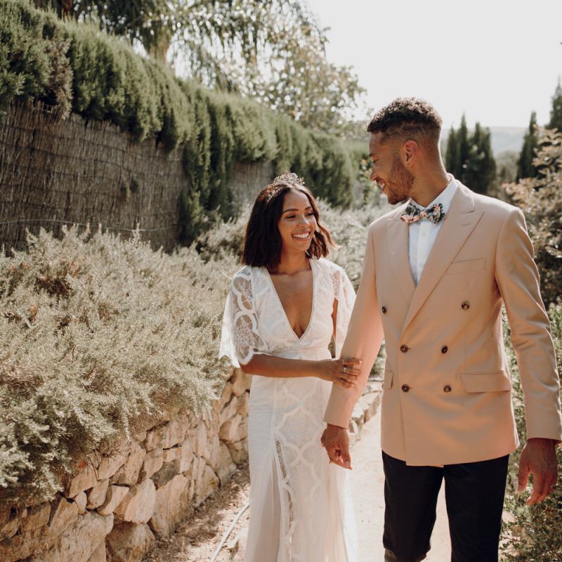 Bride in a Grace Loves Lace boho wedding dress and groom in a pink double breasted jacket at Spanish destination wedding 