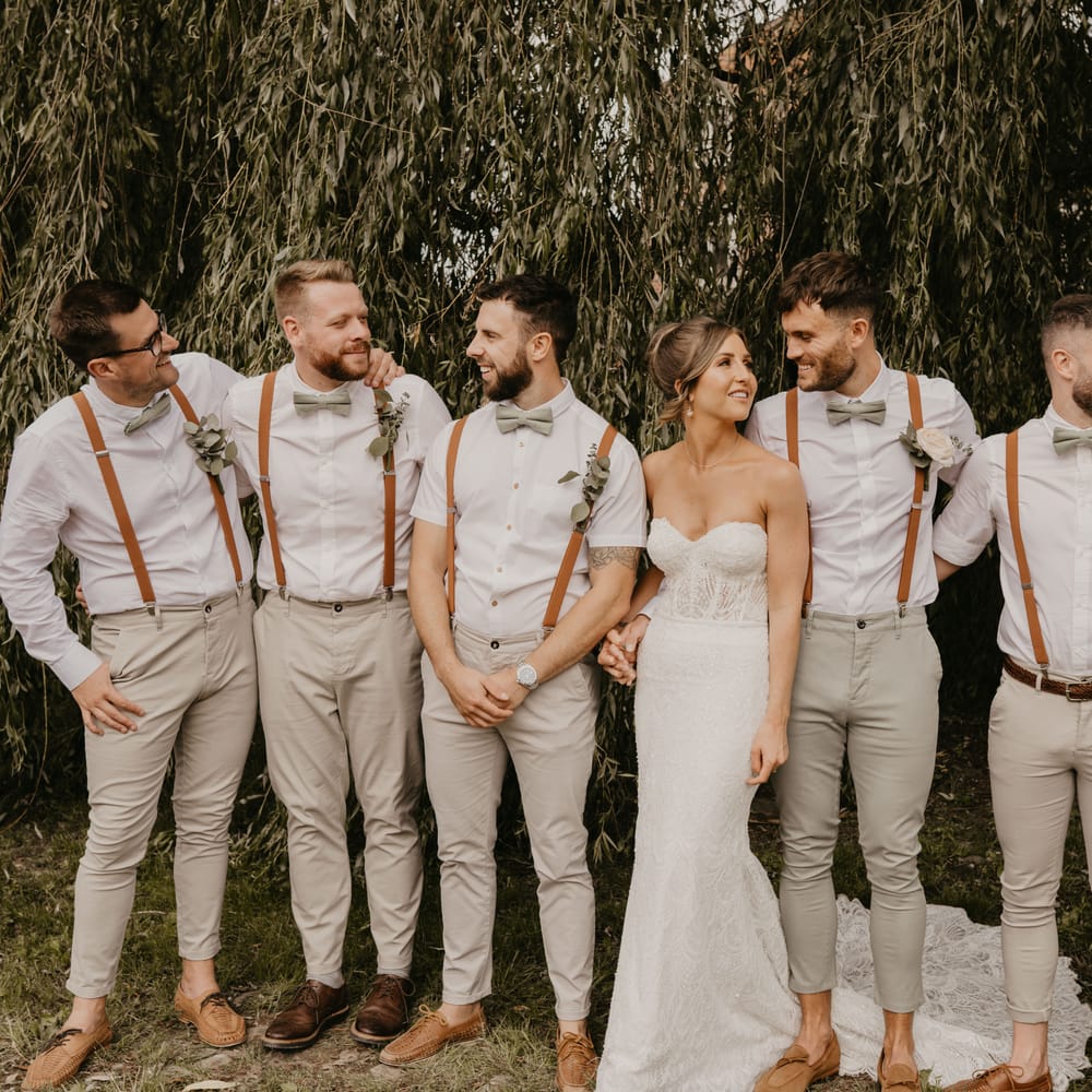 Bride & groom stand with groomsmen for Duddon Mill Farm wedding  | Mark Bamforth Photography