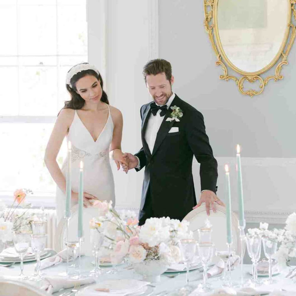 pale green wedding table decor with mint green tablecloth and taper candles and white flowers