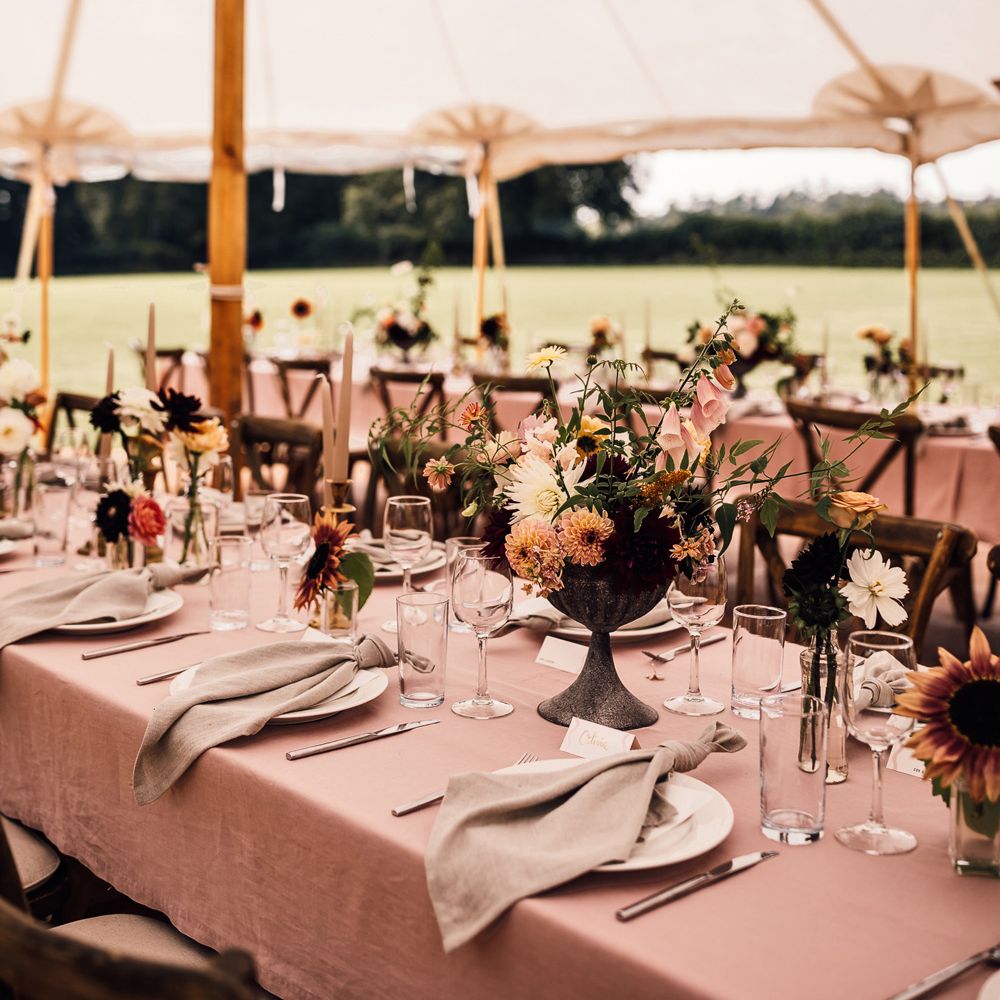 Dusky pink wedding table with florals, napkins and glassware for marquee garden wedding reception in Cornwall