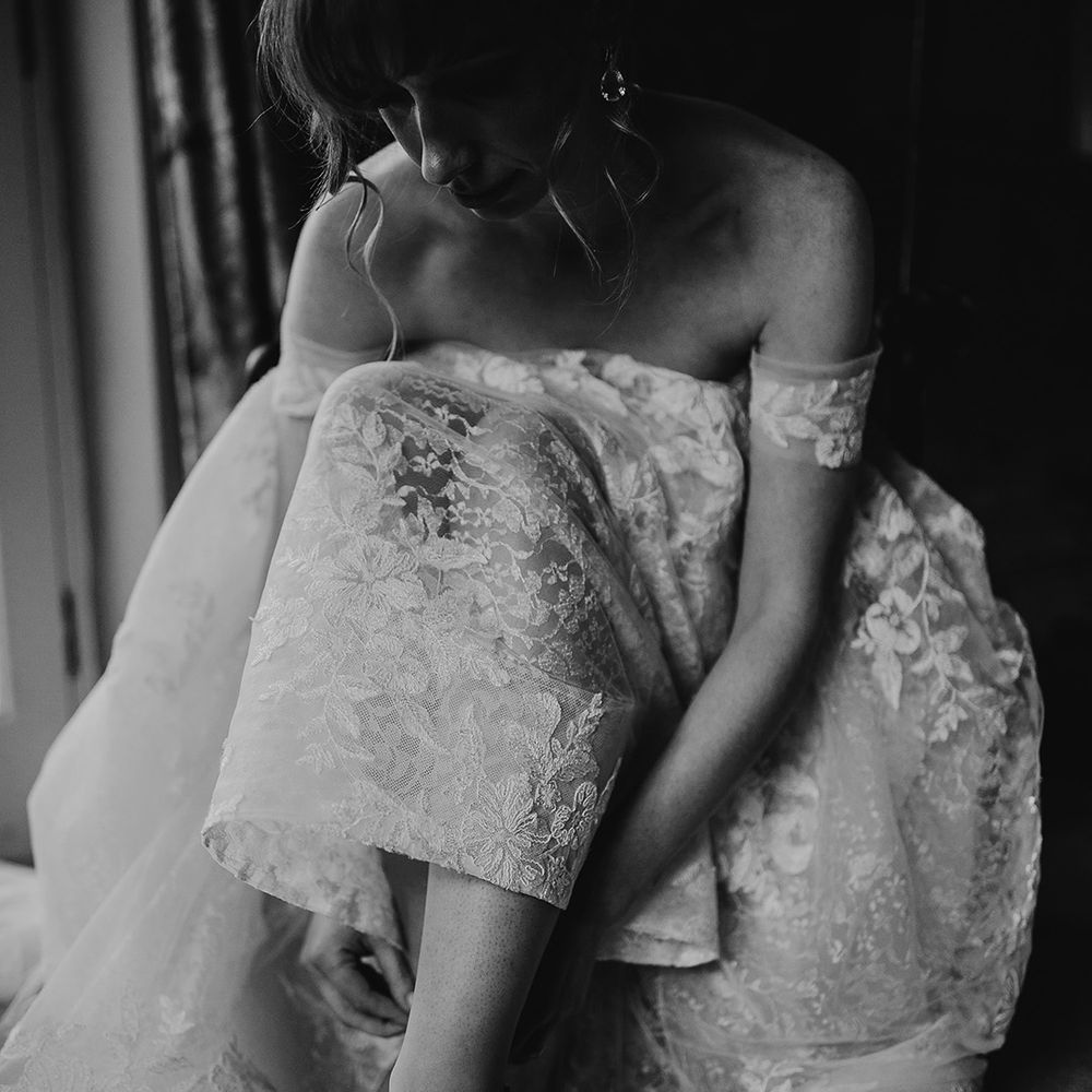 Bride puts on her Jimmy Choo wedding shoes