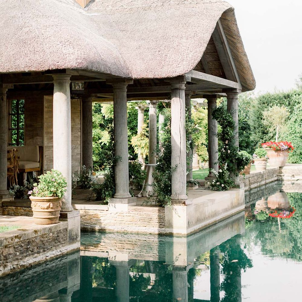 Euridge Manor outdoor wedding setting next to sparkling blue water 