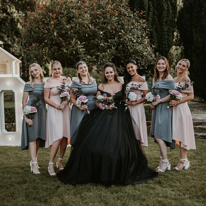 Bride stands with her bridesmaids on her wedding day