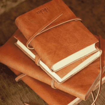 Four tan leather bound journals 