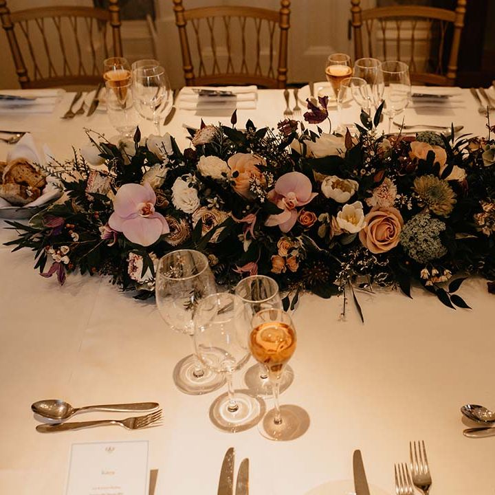 Large mixed neutral coloured floral tablescape display at wedding in Petersham Hotel 