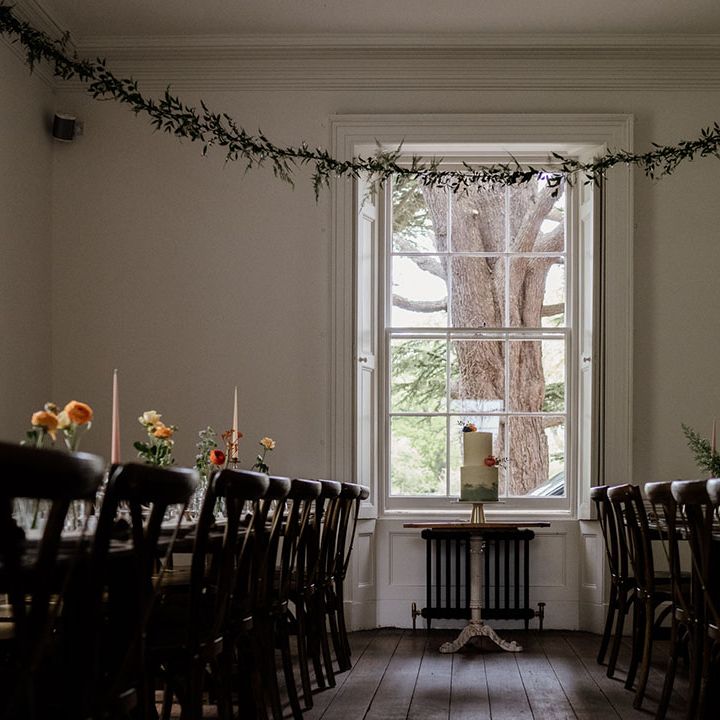 Reception room at Aswarby Rectory wedding venue decorated with colourful candles and foliage 