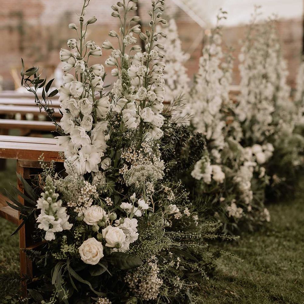 Classic tall white wedding flower aisle decoration for traditional style outdoor wedding 