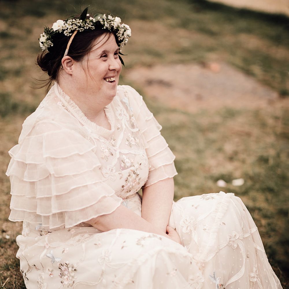 Flower girl wearing a flower crown in a Needle and Thread floral lace dress