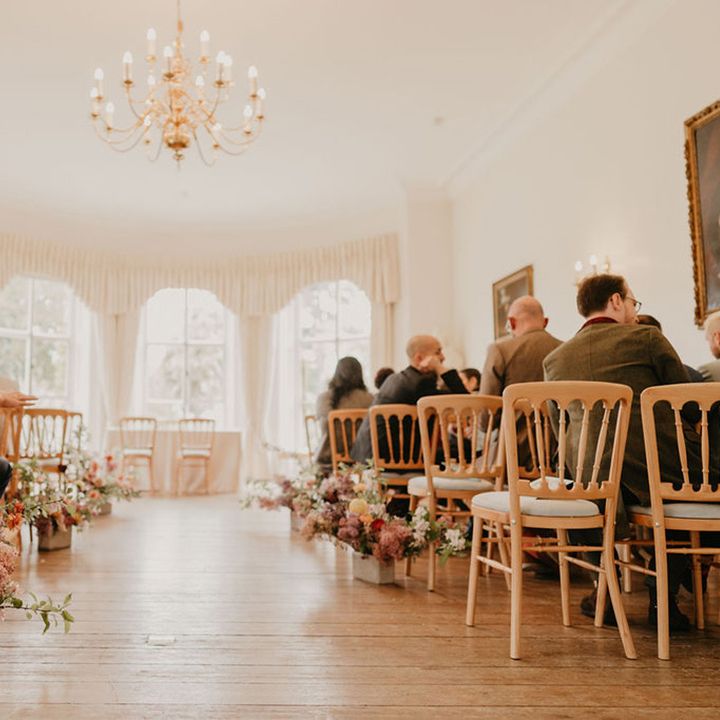 Bright floral arrangements line the aisle of Cambridge Cottage at Kew Gardens 