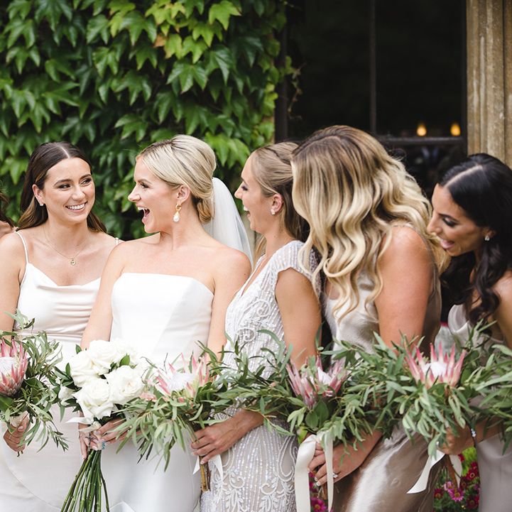 Bridal party with big group of bridesmaids in mismatched gold bridesmaid dresses with the bride 