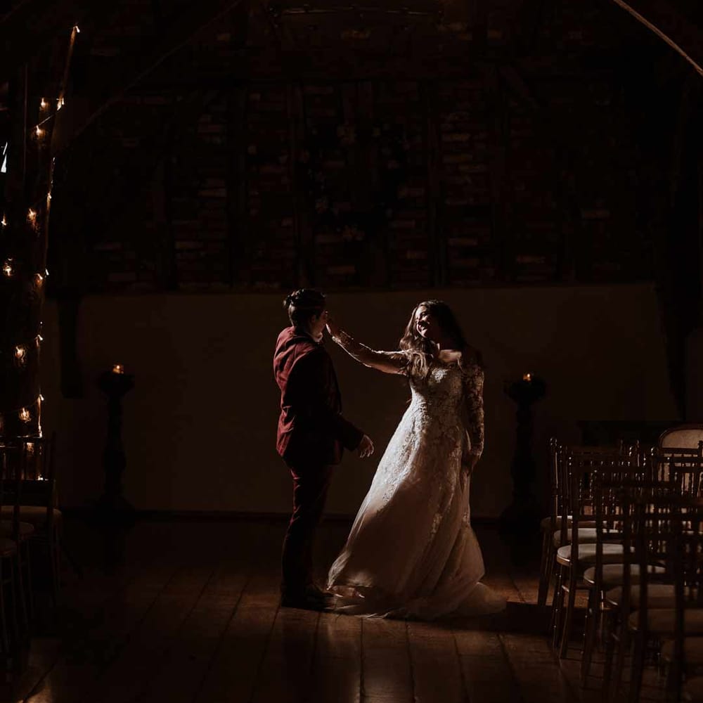 First dance wedding photo at Bassmead Manor Barns wedding venue with festoon lighting 