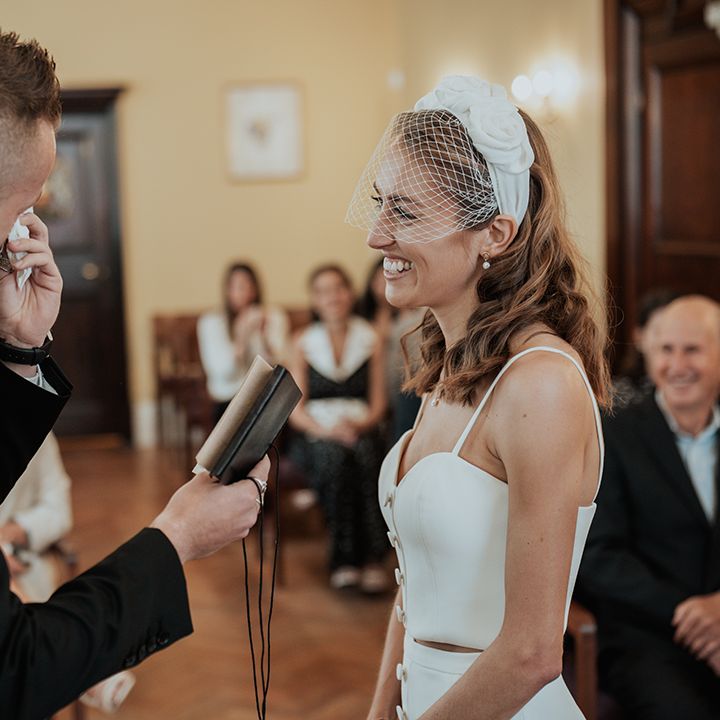 emotional groom in a black suit reading his wedding vows to his bride at their Chelsea Town hall wedding ceremony 